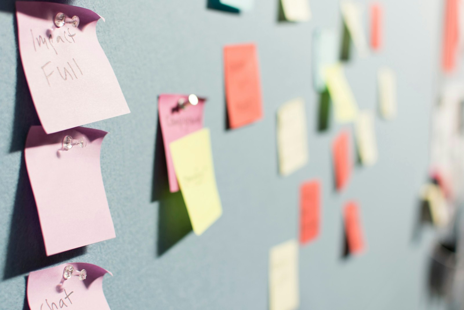 Colorful sticky notes pinned to a board