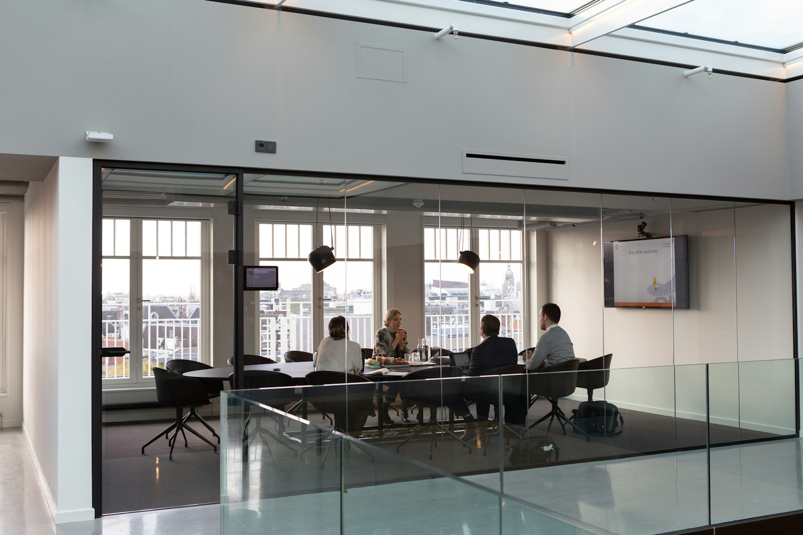 People meeting in a glass-walled conference room