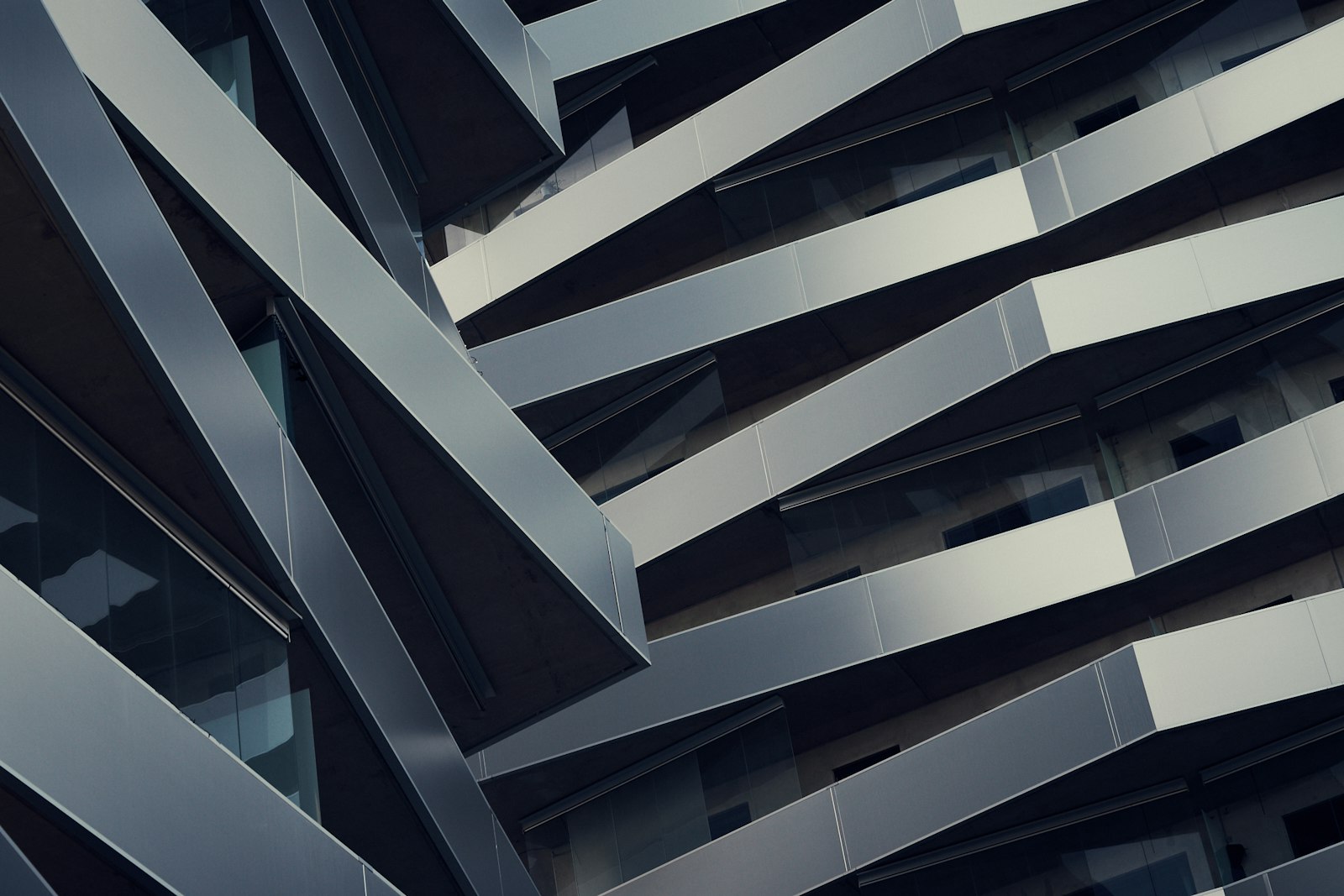 An angular gray architectural structure seen from below
